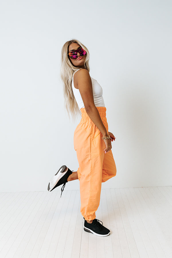 The Huxley High Waist Windbreaker Pants In Neon Orange