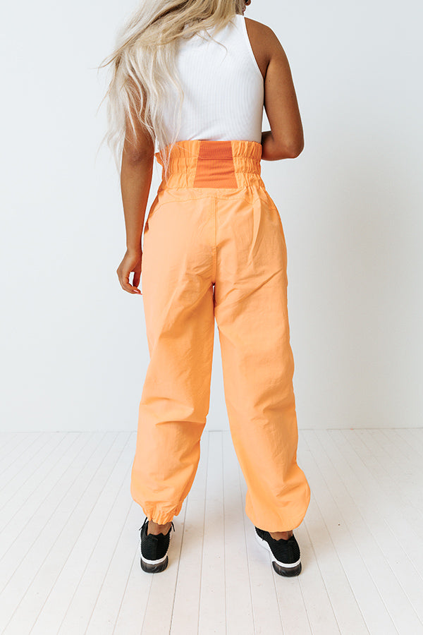 The Huxley High Waist Windbreaker Pants In Neon Orange